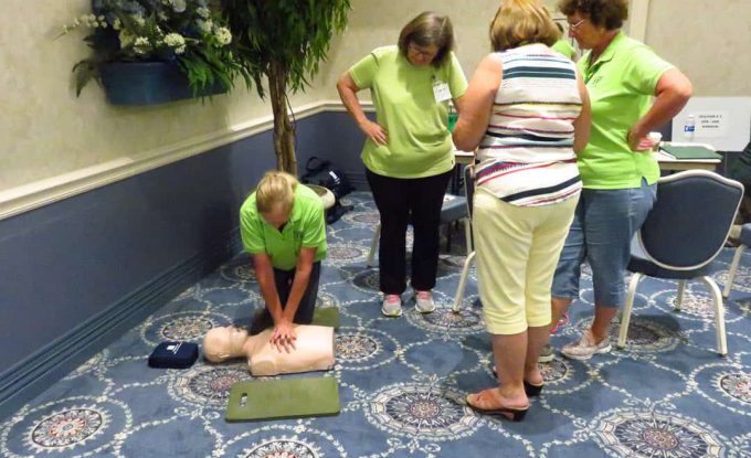 Women at CERT CPR class Woman practices CR on mannikin
